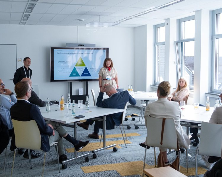 Personen sitzen in einem Workshop mit Dr. Sven Herpig und Uta Fiedler (Managerin, PD – Berater der öffentlichen Hand GmbH)
